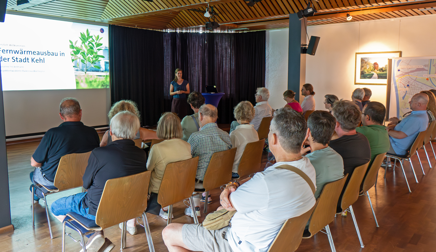 Besucherinnen und Besucher lauschen den Ausführungen von Susanne Heckelmann zum Fernwärmenetzausbau.